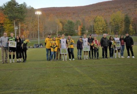Men’s Soccer Seniors Paolo Kareh, Max Whalen, Wesley Call, and Sam Edge on the field with their families during senior day. (Photo from MCLa Athletics)