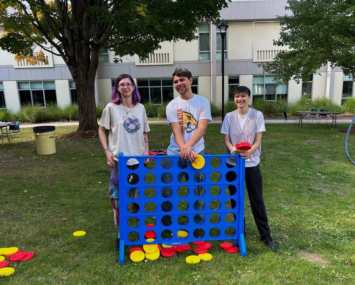 Members of MCLA's QSU play lawn games at the Welcome Back Picnic.