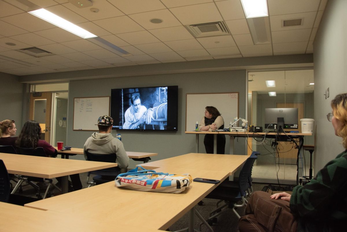 Clarke Stading, President of MCLA's TV and Film Society, shows a clip from "Frankenstein" during a presentation about the Hays Code. 