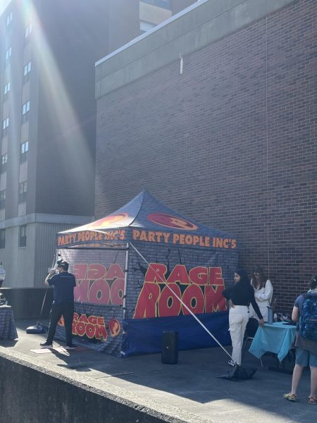 Students gather by the temporary Rage Room outside the Amlser Campus Center. 