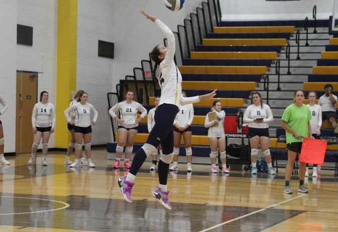 Addison Decaro serves in MCLA women's volleyball's September 27th match against SUNY Cobleskill. 