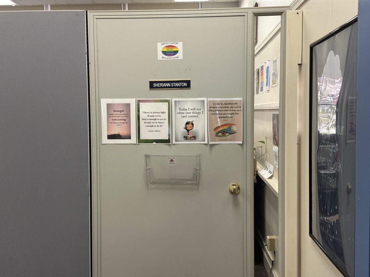 Sheri Stanton's office door decorated with quotes and a sign showing support for LGBTQIA+ students.