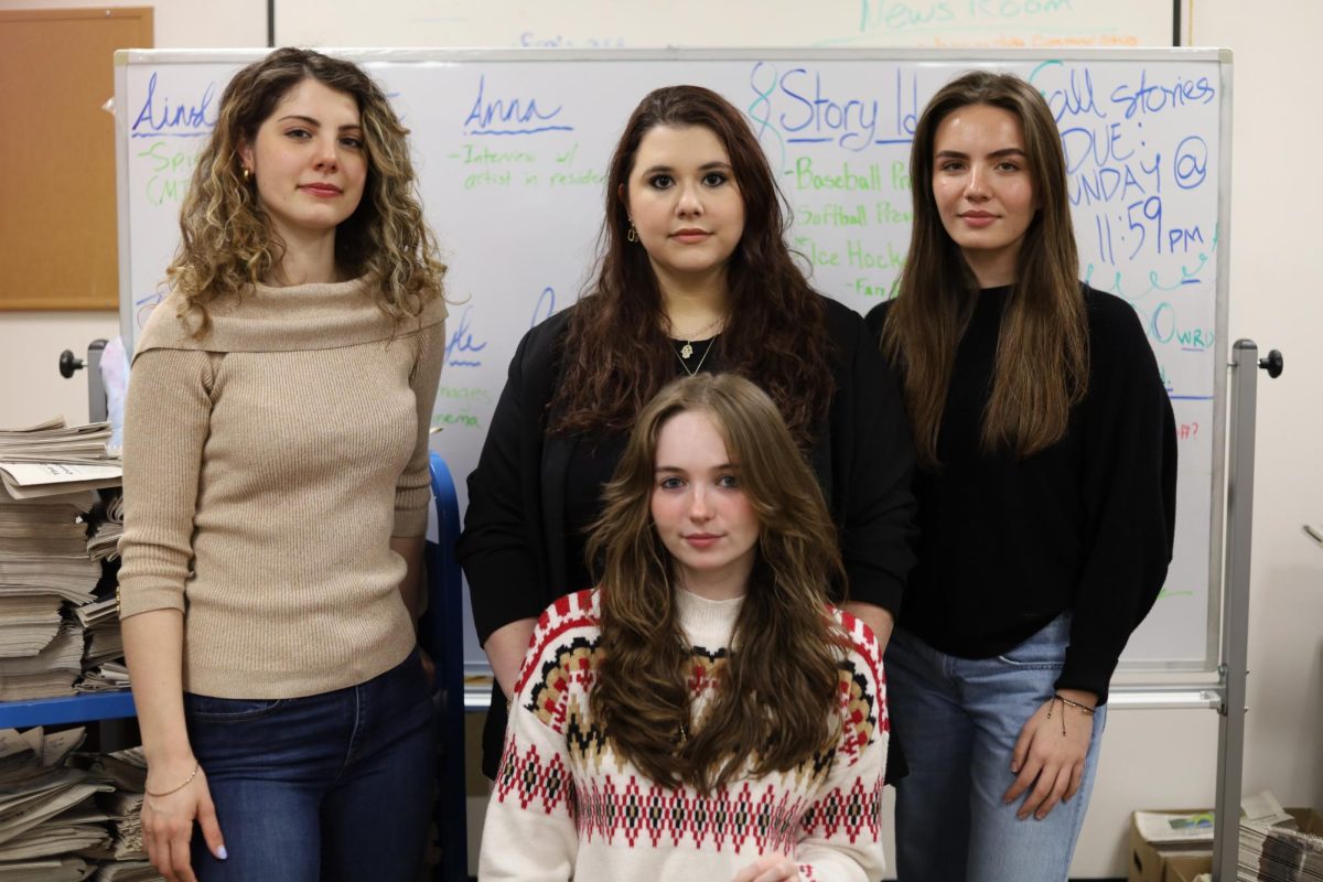 The Beacon and Beacon Web News editors Fallon Maloney, left, Kate Zelkowitz, top center, Ainslie Lafko, bottom center, and Anna Najimy, right, in The Beacon office, Thursday, April 3, 2025, in Freel Library.